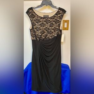 This is a woman’s black dress with cream underlay. Size 12, new with tags.